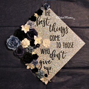 May include: A silver glitter graduation cap decorated with blue and white flowers and the quote "The best things come to those who don't give up."