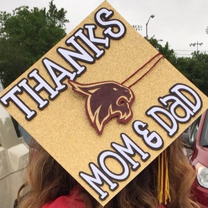 Thanks Mom and Dad Custom Graduation Cap Topper!  Personalize the hat topper for name, degree, school. graduation year, colors!