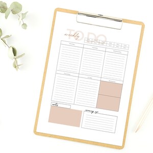 May include: A weekly to-do list planner with sections for Monday through Sunday, notes, and coming up. The planner is on a clipboard with a brown background.