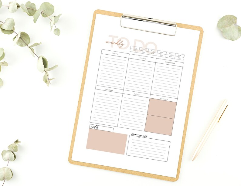 May include: A weekly to-do list planner with sections for Monday through Sunday, notes, and coming up. The planner is on a clipboard with a brown background.