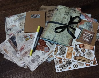 May include: A collection of steampunk-themed stationery items, including notebooks, cards, stickers, and pens. The items feature vintage map and gear designs, with a brown and beige color scheme. A black ribbon ties a stack of notebooks together. The text "Yesterday is gone, tomorrow has not yet come" is visible.