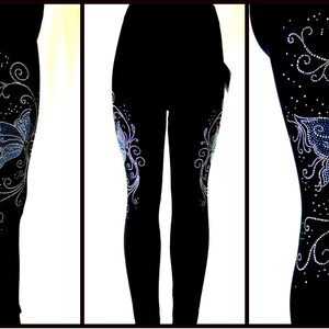 May include: Black leggings with a blue and silver butterfly design made of rhinestones. The butterfly design is on the side of the leg and has a floral pattern.
