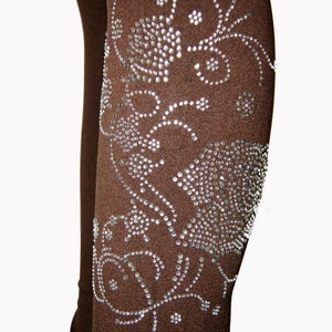 May include: Brown leggings with a silver rhinestone floral design.