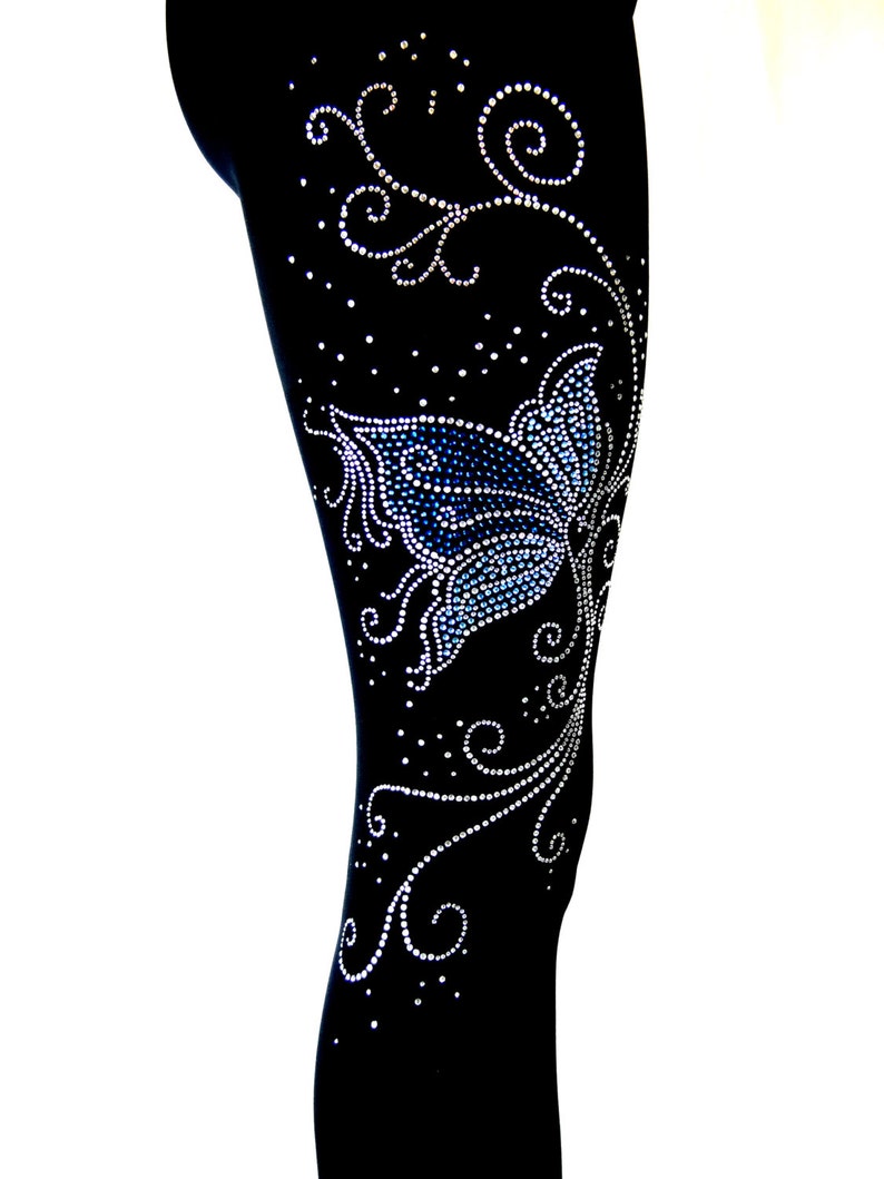 May include: Black leggings with a blue butterfly and silver rhinestone embellishments in a floral design.