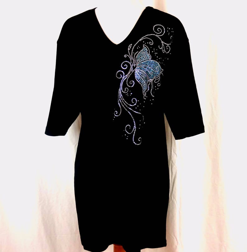 May include: Black t-shirt with a blue and silver rhinestone butterfly design on the front.