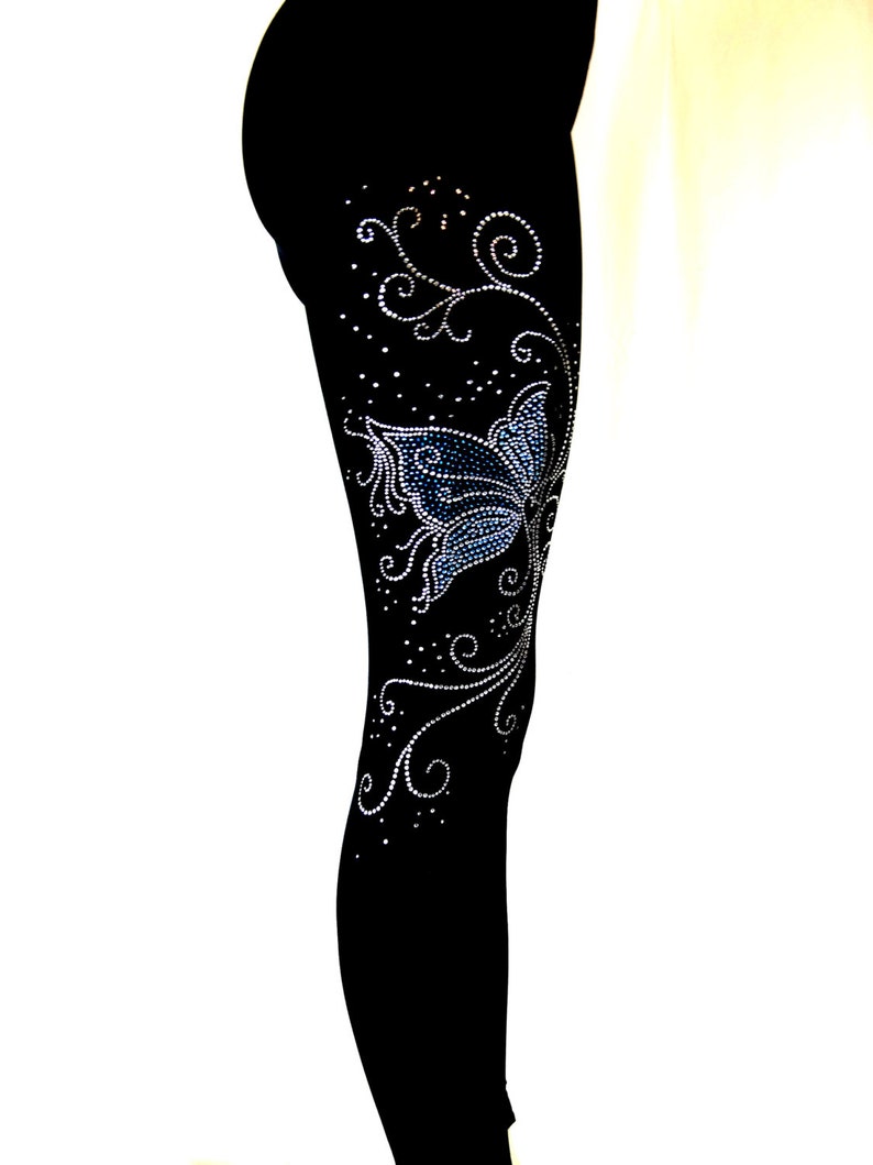 May include: Black leggings with a blue butterfly and silver rhinestone embellishments in a floral design.