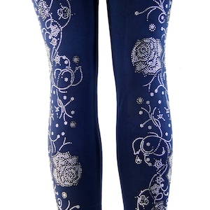 May include: Navy blue leggings with a floral design made of silver rhinestones.