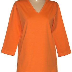 May include: A bright orange, long-sleeved, v-neck t-shirt.