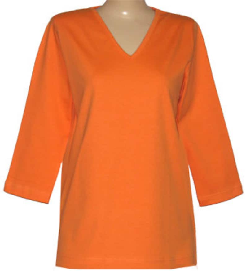 May include: A bright orange, long-sleeved, v-neck t-shirt.