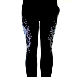May include: Black leggings with a rhinestone design on each leg. The design features a stylized butterfly with swirls and dots.