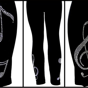 May include: Black leggings with a rhinestone treble clef design on the calf and a rhinestone musical note design on the ankle.