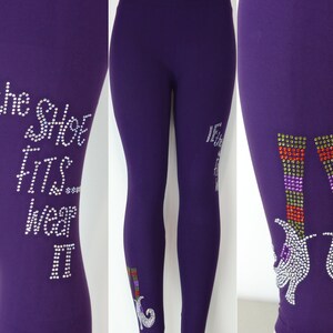 May include: Purple leggings with a rhinestone design featuring the text "If the shoe fits wear it" and a pair of witch's shoes.