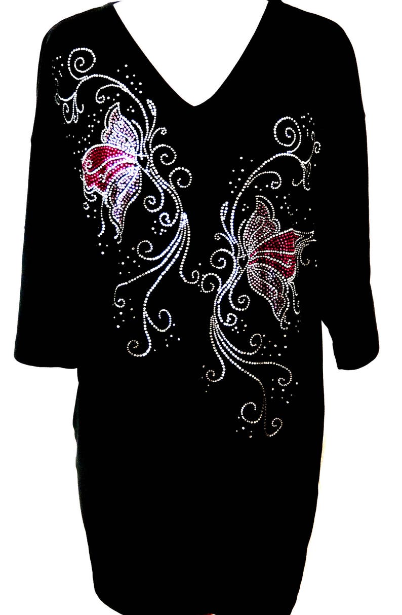 May include: Black t-shirt with a rhinestone design of two butterflies and floral accents.
