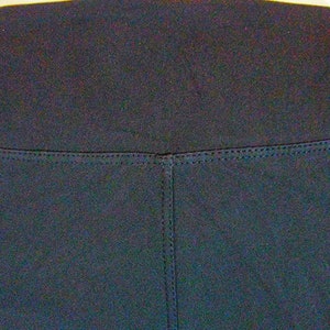 May include: Black leggings with a high waistband and a seam down the center of the front.