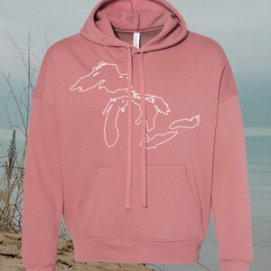 May include: A dusty rose colored hoodie with a white outline of the Great Lakes on the front.