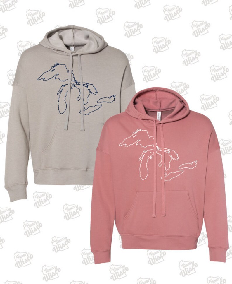 May include: Two hooded sweatshirts with a graphic of the Great Lakes. One sweatshirt is a light gray color with a navy blue outline of the Great Lakes. The other sweatshirt is a dusty rose color with a white outline of the Great Lakes.