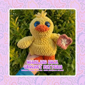 May include: A crocheted yellow duck with orange feet and beak, blue eyes, and a small pink and white flower. The text "WISHLING DUCK CROCHET PATTERN" is displayed on the image, along with additional text indicating it's beginner-friendly.