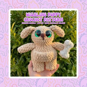 May include: A crocheted puppy with large green eyes and a brown nose, holding a white bone. The puppy is beige and has floppy ears. Text on the image reads "WISHILNG PUPPY CROCHET PATTERN".