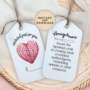 May include: Two white gift tags tied with brown twine. One tag features a pink crocheted heart and the text "crocheted just for you". The other tag has the word "Amigurumi" and a definition. A tan circle reads "Instant PDF Download".
