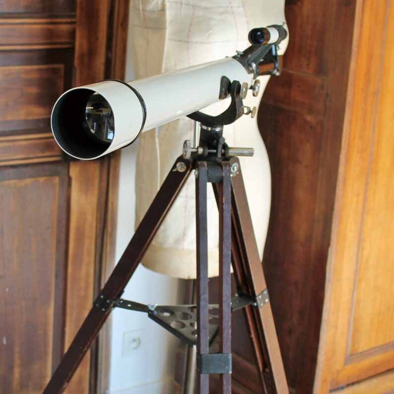 Vintage astronomy telescope with wooden tripod stand and