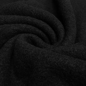 May include: Black fabric with a soft, fuzzy texture. The fabric is folded and draped, showing its texture and drape.