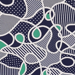 May include: A navy blue fabric with a white rope pattern and green and white geometric shapes. The fabric has a nautical theme.