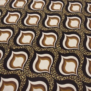 May include: A repeating pattern featuring retro teardrop shapes in white, brown, and black, set against a leopard print background. The design has a 1970s aesthetic, suitable for fabric or wallpaper.