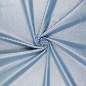 May include: A close-up of a light blue fabric with a subtle shimmer. The fabric is folded and draped in a spiral pattern.