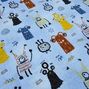 May include: Blue fabric with a repeating pattern of colourful cartoon monsters. The monsters have different shapes, sizes, and colours, including yellow, orange, brown, and blue.