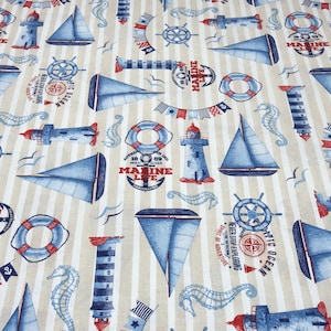 Könnte beinhalten: Stoff im maritimen Stil mit beige-weiß gestreiftem Hintergrund. Der Stoff zeigt blaue Segelboote, Leuchttürme, Rettungsringe, Seepferdchen und nautische Flaggen. Text enthält "Marine Life" und "Arctic Ocean".