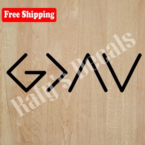 May include: Black and white graphic design of the word "God" with the letters stylized as arrows pointing upwards. The design is on a light wood background.