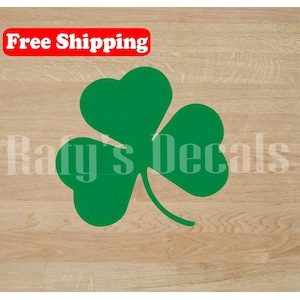 May include: Green shamrock decal, a three-leaf clover, on a wood background. Free Shipping.