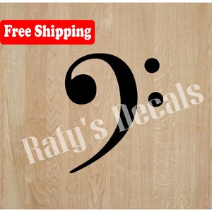 May include: Black bass clef musical symbol on a light wood grain background. The image includes the text "Rafy's Decals" and a red rectangle with the words "Free Shipping".