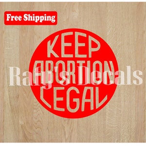 May include: Red circle sticker with the text "KEEP ABORTION LEGAL" in white letters.