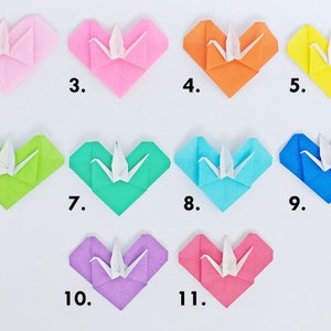 May include: A collection of eleven origami hearts in various colors, each with a white origami crane in the center. The hearts are numbered 2 through 11, and include pink, orange, yellow, green, blue, and purple.