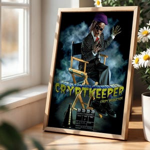 May include: A framed poster featuring the Cryptkeeper sitting in a director's chair, wearing a purple hat, sunglasses, and a patterned blazer. The text reads THE CRYPTKEEPER CREPY PRODUCTION, with a director's megaphone and a film clapperboard below.