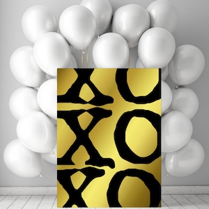 May include: A gold-colored canvas print with black XOXO letters and a background of white balloons. The print has a metallic gold gradient. The balloons are white and clustered together.