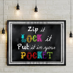 May include: A rectangular black chalkboard sign in a silver frame featuring the white and multi-colored text: Zip it, LOCK it, Put it in your POCKET. The words LOCK and POCKET are displayed in vibrant, decorative, multi-colored block lettering.