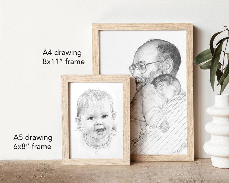 May include: Two framed pencil drawings, one of a father holding a sleeping baby and the other of a baby smiling. The larger drawing is in an 8x11 inch frame and the smaller drawing is in a 6x8 inch frame.