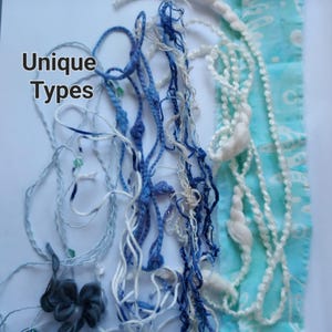 May include: A collection of various textile trims and yarns in shades of blue and white, including braided, knotted, and textured strands, alongside a light blue fabric strip with a white pattern. The text "Unique Types" is visible on the left.
