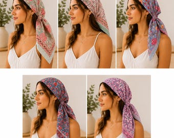 May include: A collection of five square head scarves featuring various floral and paisley patterns in shades of pink, blue, green, and purple. Each scarf is tied at the back of the head, displaying intricate borders and detailed botanical prints.
