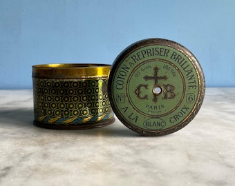 A vintage French Cartier Bresson lithographed thread tin and 6 spools of thread