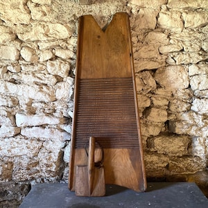 A very large vintage French wooden washboard and paddle, beater