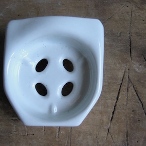 A vintage French white porcelain toothbrush holder, glass holder