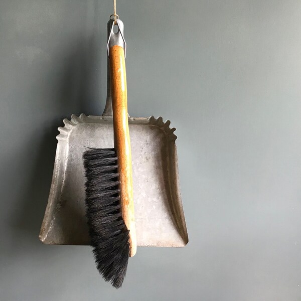 A vintage French dustpan and brush