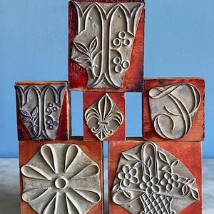 A set of vintage French rubber printing stamps, rubber stamp blocks, flowers, initials