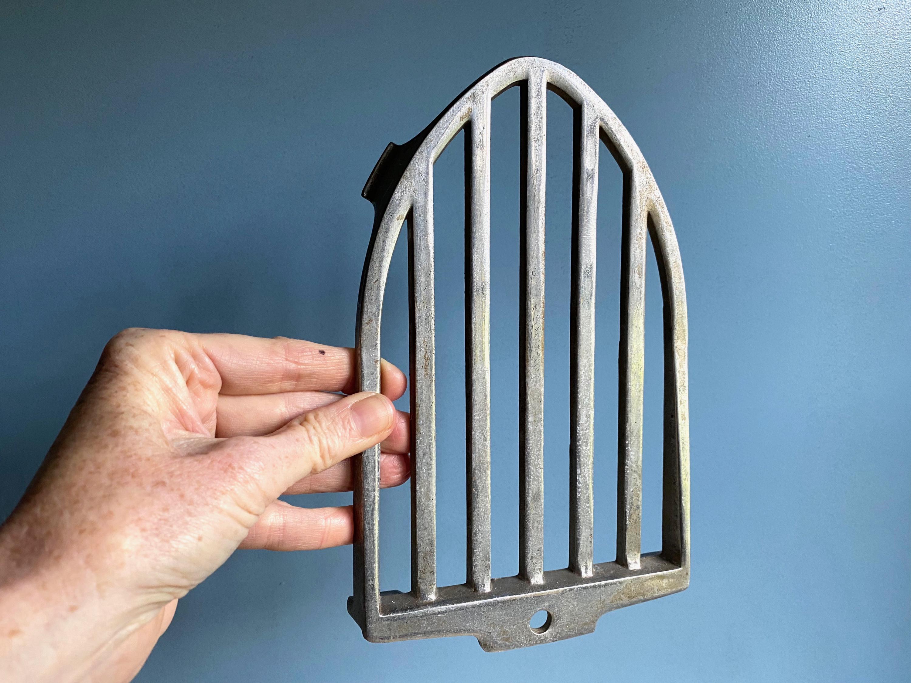 A vintage French aluminium iron trivet