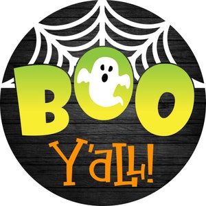 May include: A black and white spiderweb with a ghost in the center. The words "BOO Y'all!" are written in yellow and orange letters on a black wooden background.