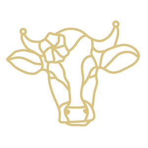 May include: A gold-colored line art illustration of a cow's head, featuring a flower on its forehead. The design has a stained-glass effect, with the cow's face and ears outlined in gold against a white background.