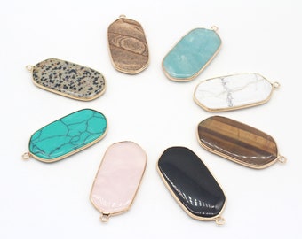 May include: Assortment of eight different gemstone pendants with gold-toned metal settings. The pendants are shaped like rectangles with rounded edges and feature various natural stone patterns, including turquoise, tiger's eye, and marble.